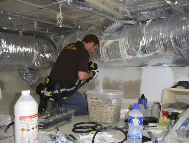 Duxbury Air Duct Cleaning specialist performing professional mold removal from air ducts in Duxbury
