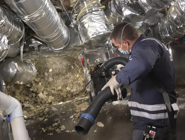 Duxbury Air Duct Cleaning specialist operating negative pressure cleaning equipment for thorough duct maintenance in Duxbury