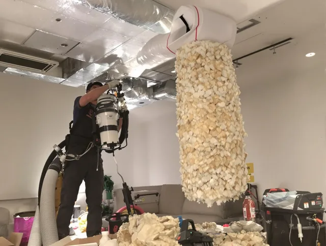 Duxbury Air Duct Cleaning technician performing precision vacuum insulation removal in a residential property in Duxbury